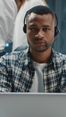 Wall Mural - portrait afro-american it administrator wearing headset speaker microphone programming software posi