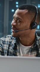 Wall Mural - african american satisfied it worker wearing headset dancing with funny colleague at workspace. comp