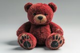 Vintage red teddy bear with worn features on neutral background  evoking nostalgia and comfort