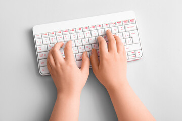 female hands with modern computer keyboard on light background