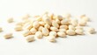 © Latsamee - Scattered white beans on pure white background, tabletop, overhead shot, harvest