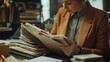 © Bejo - Woman reviewing documents in library archive