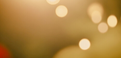 blurred image of multiple round bokeh lights in various sizes, creating a warm and soft glow against