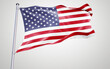 © Mulkan - American flag waving in the wind against the sky with red, white, and blue stripes and stars, symbolizing patriotism and freedom
