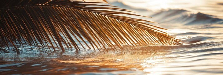 Wall Mural - tranquil sunset scene with a palm frond silhouetted against golden ocean waves, capturing the serene