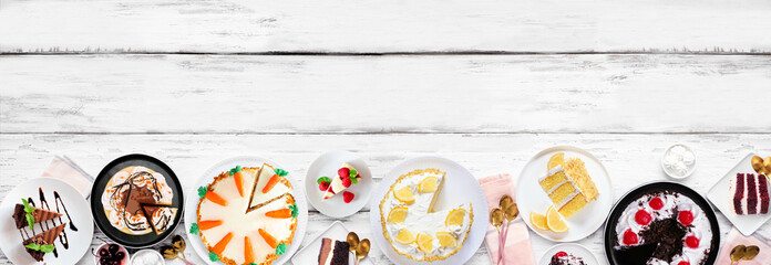 Leinwandbilder - Dessert bottom border with a variety of cakes. Top down view over a white wood banner background. Copy space. Black forest, lemon, carrot, red velvet, chocolate and cheesecakes.