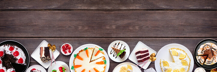 Leinwandbilder - Dessert bottom border with a variety of cakes. Top down view over a dark wood banner background. Copy space. Black forest, lemon, carrot, red velvet, chocolate and cheesecakes.