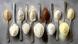 © CreativeUniverse - Metal spoons of various gluten free flour, top view
