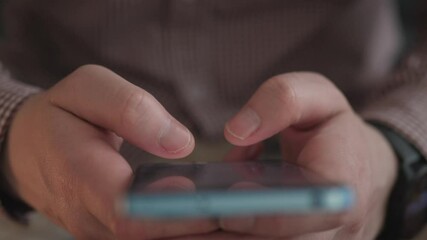 close phone and male hands typing a message on social media