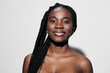© SHOTPRIME STUDIO - Smiling Black woman with braided hair against a light background, showcasing confidence and beauty in a modern portrait style Perfect for diversity and empowerment themes