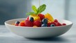 © keshia - A beautifully styled bowl of mixed berries with a drizzle of honey and mint leaves. Featuring a healthy, vibrant snack