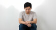 © yogigallery - A photo of an Asian man with a sad and unattractive face.