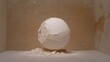 © PACESTOCK - Cracked white plaster sphere with crumbling debris sits in a minimalist room with textured beige walls under soft dramatic spotlighting.