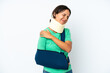 © luismolinero - Young hispanic woman wearing a neck brace and sling isolated on white background suffering from pain in shoulder for having made an effort