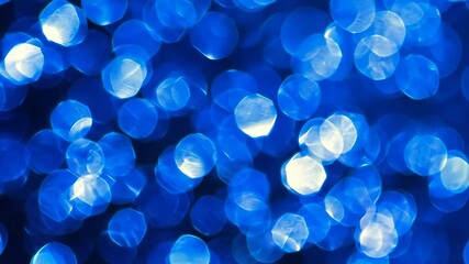 Abstract pattern of illuminated and blurred blue orbs creates a glowing, vibrant, and dreamy effect with a bokeh background