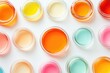 © prophoto - Assortment of colorful cosmetic creams in small glass jars on white background.