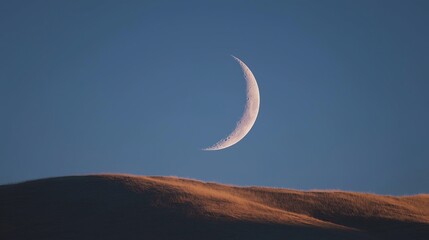 Fototapete - A crescent moon hanging over a dark sea, simple and serene.