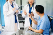 © Nuttapong punna - Hospital Ward Male and  Male Professional Asian Doctors Talk with a Patient, Give Health Care Advice