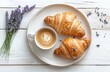 © Chatchanan - A flat lay composition of a simple breakfast, crispy croissants,