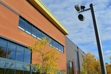 Aufkleber - Modern architectural details of a commercial building complemented by autumn foliage and surveillance technology