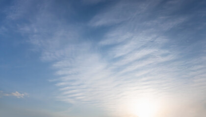 Poster - Blue sky and white clouds background - Pillowy clouds cover a blue sky in the background