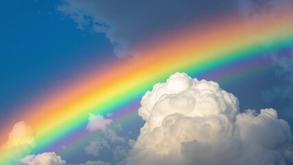 Poster - A vibrant rainbow arcing through fluffy, sunlit clouds, wonder, phenomenon
