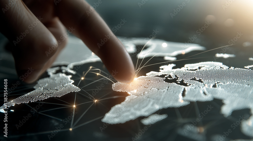Finger touching a digital world map with network connections and ...