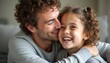 © natakot - A smiling father and his young daughter share a heartwarming moment, their faces radiating joy and love. This tender scene captures the essence of family bonds, showcasing the pure happiness that