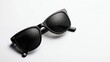 © Igorbmm - Stylish black sunglasses with dark lenses on a clean white surface. Perfect for eye protection with a minimalist design.