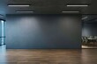 © Who is Danny - Modern black wall mockup in office with wooden floor and meeting room visible through glass wall on right side under ceiling lights at night.