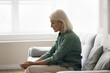 © fizkes - Facing retirement challenges. Sad upset older woman sit alone on couch suffer of loneliness isolation depression solitude disease reflecting on memory health problems at home or in senior care center
