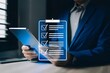 © SHAFIKURGD6 - Checklist online document practices and policies concept, Businessman use tablets to check steps through policies document company articles of association Terms and Conditions, Quality inspection
