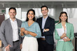 © fizkes - Diverse business team of happy colleagues and Latin female leader standing together in office, looking at camera, smiling. Positive successful project manager posing for group portrait