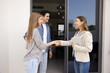 © fizkes - Real estate agent shakes hands young couple. Happy spouses purchasing, renting home, handshake realtor, finalizing property deal, make agreement, sign contract. Ownership, professional client services