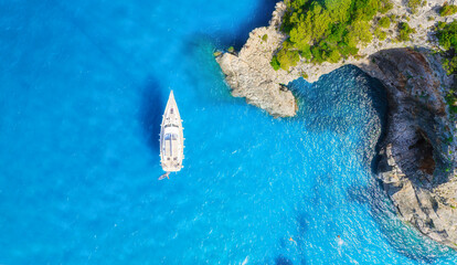 Wall Mural - drone view of the sea coast and yacht. rocky shore and sea water. vacation and travel. summer seasca