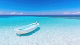 A small white boat floats in calm, turquoise water. The composition is serene, showing a clear sky and tranquil ocean. The image is high-resolution, with vibrant colors and natural lighting. It has