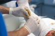 © Carmen - Doctors applying bandage on injured leg in operating room