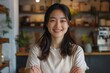 © NikoG - Portrait of a smiling young Asian woman small business owner