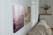 © New Africa - Canvas with different printed photos on white wall indoors