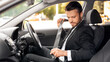 © Prostock-studio - Driving safety concept. Handsome businessman fasten seat belt in his car, ready to go to office. Man in stylish suit putting on his seatbelt before driving car to airport, side view
