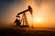 © sornram - Silhouette of an oil pump against a stunning sunrise, showcasing the essence of energy production and industrial activity.