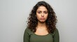 © DWIJ - woman with curly hair standing nervously over a grey background