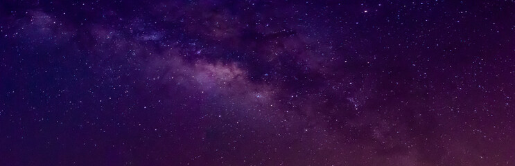 Wall Mural - milky way in night sky and stars on dark background with noise and grain. long exposure and white ba