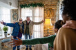 © NDABCREATIVITY - Excited multiethnic family greeting grandparents on Christmas Day. Multi-generational happy family