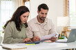 © weedezign - Couple budgeting and calculating tax with laptop at home, managing finance and planning for longterm investment