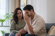 © weedezign - Supportive couple in emotional moment at home as woman struggles with sadness and stress, expressing