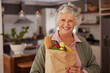 © Rido - Happy senior woman holding vegetables shopping bag