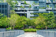 Modern eco-friendly architecture with vertical garden and greenery surrounding office glass building in urban environment in Bangkok city, Thailand. Green architecture and sustainable design