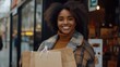 © uu - Smiling woman with shopping bags after a successful shopping spree in the city.