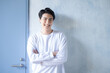 © kapinon - Smiling fresh young man in T-shirt Image of choice or future mind with door in background